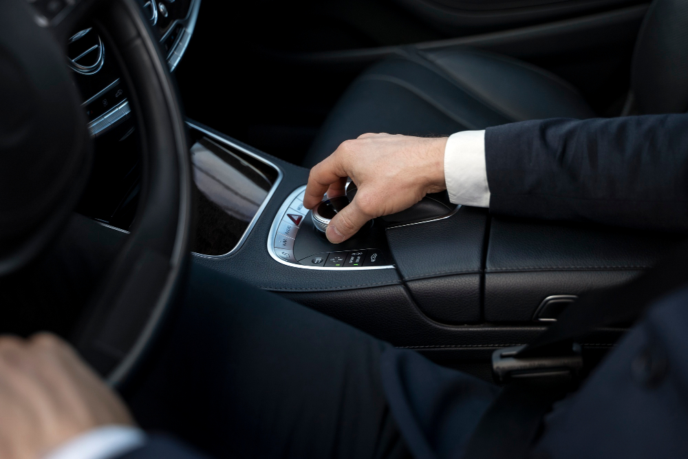 Chauffeur hand on the gear selector of a transfer vehicle in Milos
