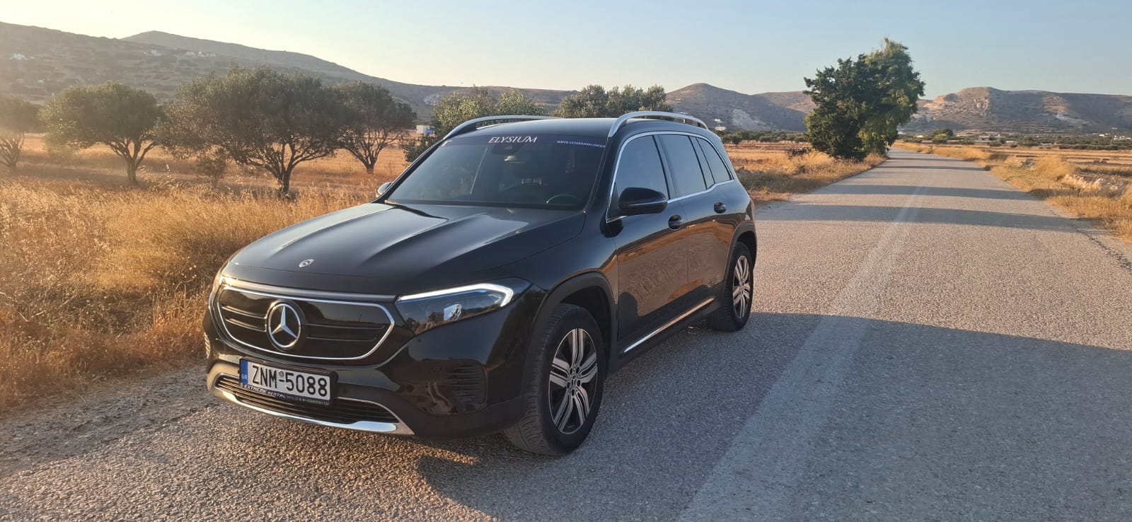Black Mercedes-Benz SUV from the Elysium Transfer Milos fleet on a road in Milos